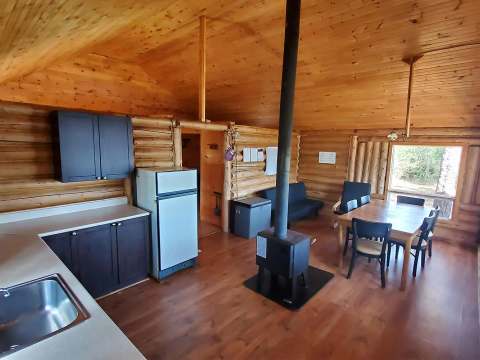 Overview of the open concept area featuring the kitchen, dining room, and wood stove.