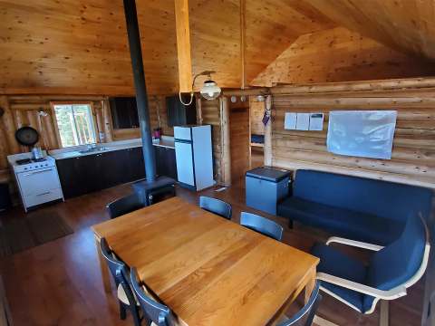 Overview of the rustic kitchen and dining area in the cabin.