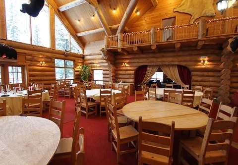 The inn's dining room features log construction and a mezzanine.