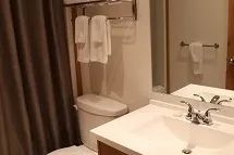The functional bathroom at the inn features a sink and clean towels.