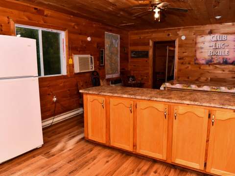 The fully equipped kitchen of the Bear Lodge cabin features a large central island and a refrigerator.