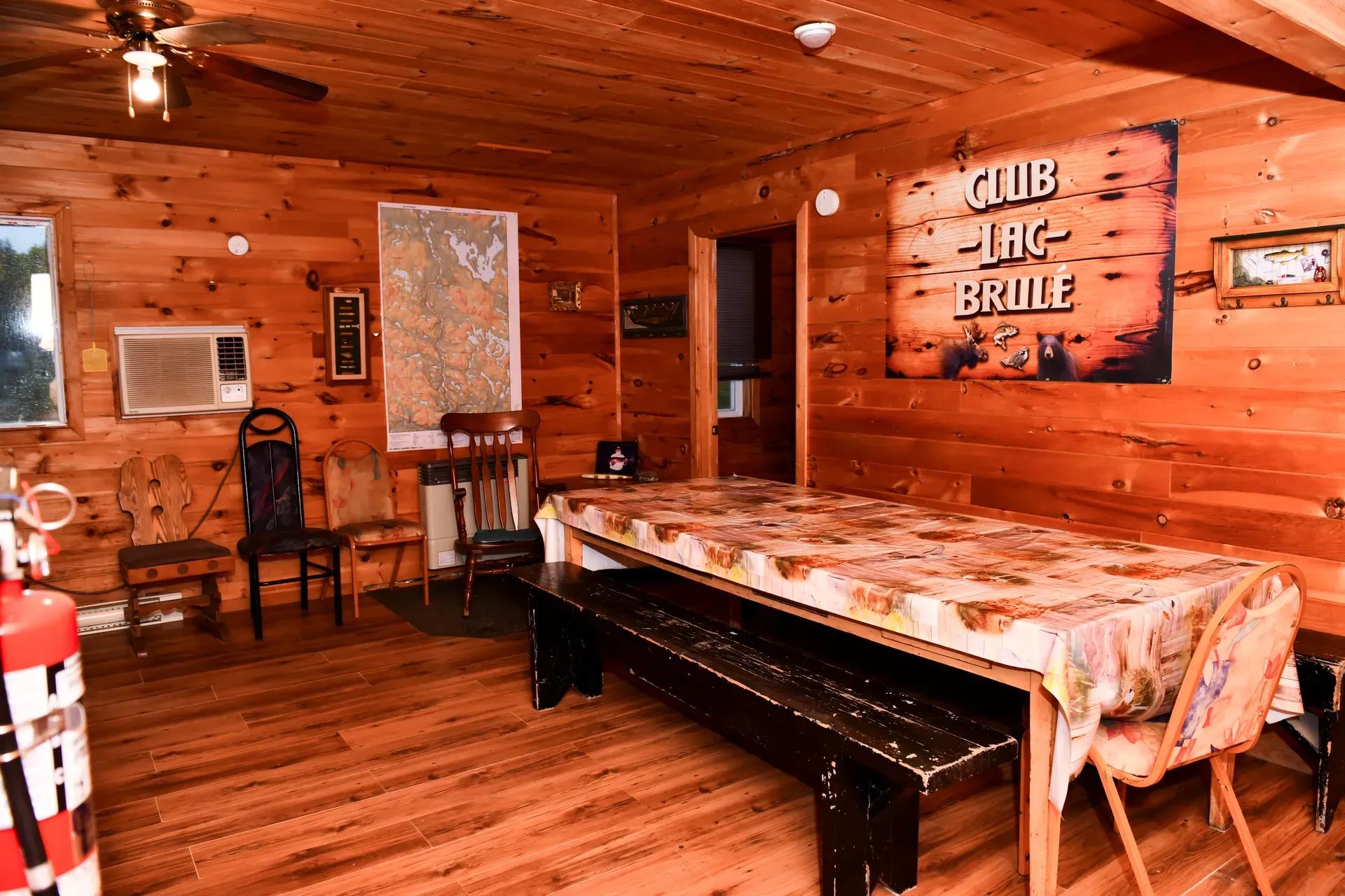 The Bear Lodge dining room offers a warm atmosphere with its wooden walls.
