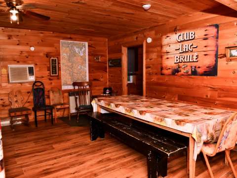 The Bear Lodge dining room offers a warm atmosphere with its wooden walls.