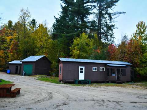 Exterior view of the Bear Lodge surrounded by a forest in autumn colors.