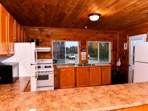 The Bear Lodge kitchen is equipped with full appliances and a rustic wood countertop.