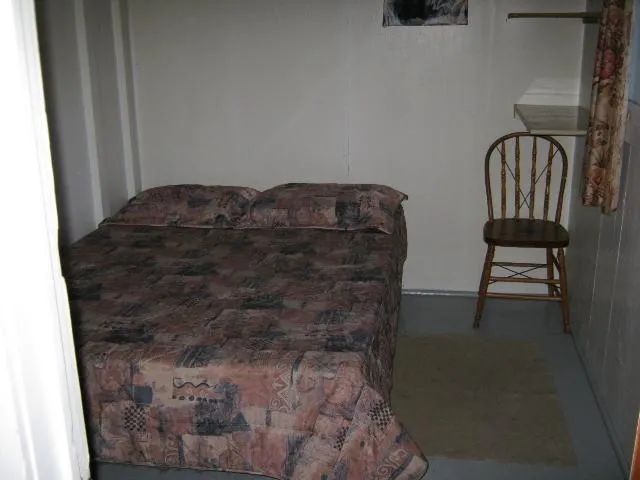 This bedroom in cabin number three is equipped with a double bed.