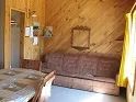 The living room of cabin number 7 includes a comfortable sofa and a dining table.