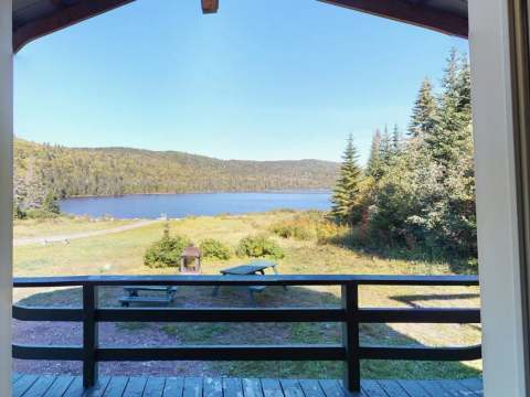 Panoramic view of the lake and forest from the Chalet Juliette deck.