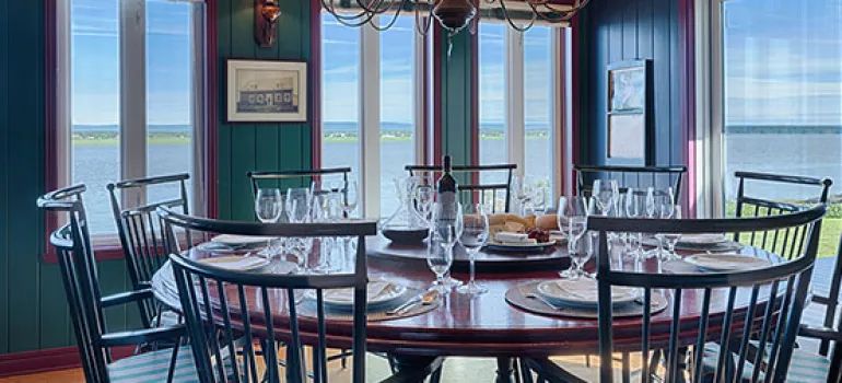 The main house dining room offers a panoramic view of the water.