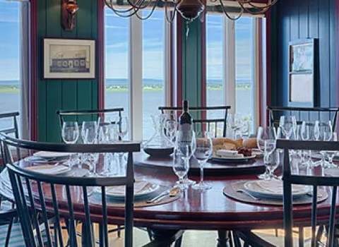 The main house dining room offers a panoramic view of the water.
