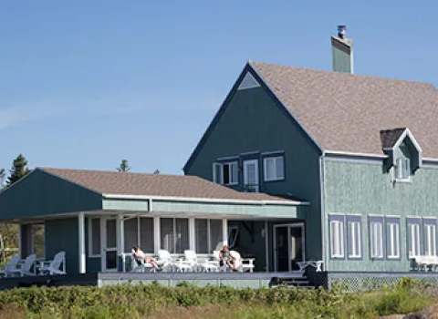 The main house offers a large outdoor deck furnished for enjoying nature.