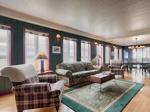The bright living room of the main house offers a comfortable relaxation area with a view of the water.