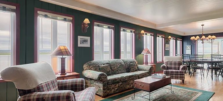 The main house features a bright living area with a lounge and a dining room.