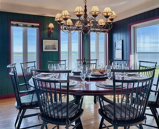 The main house dining room features a panoramic view of the water.