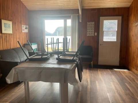 Living area inside the Hirondelle cottage with a view of the water.