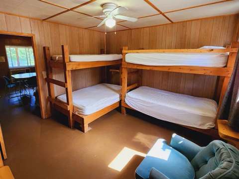 This suite features wooden bunk beds and a comfortable armchair.