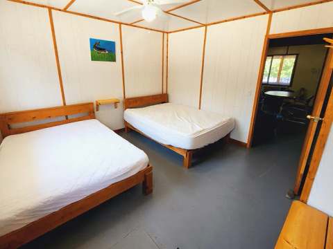 This bedroom features two double beds and provides access to another room in the suite.