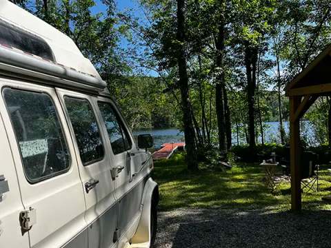 View of the dock and lake from a campsite at Camping le Totem.