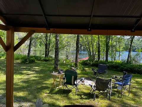 View of the lake and relaxation area from the campsite shelter.