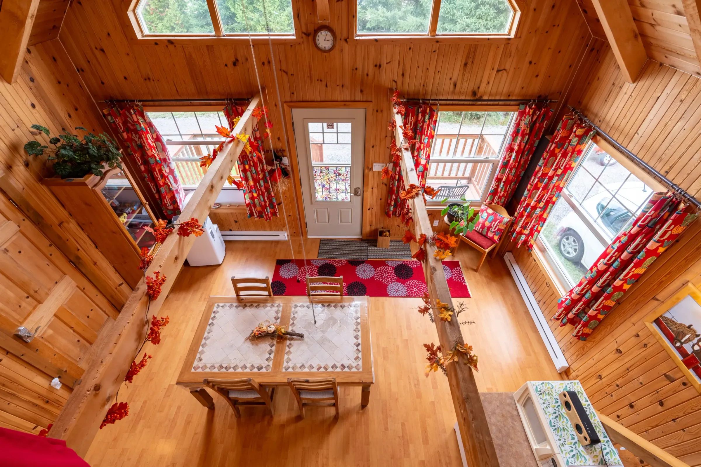 High-angle view of the open-concept living area and bright dining room of Les Lucioles cottage.