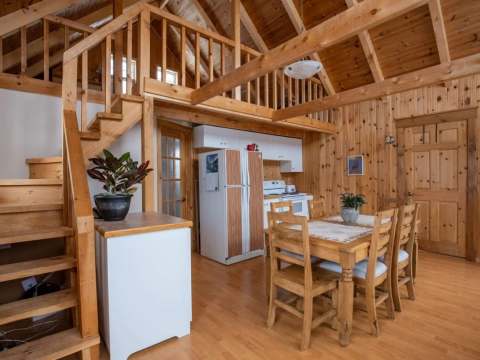 Open living area featuring an equipped kitchen and dining space inside the cottage.