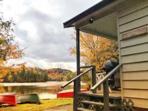 View of the lake from the porch of Le Héron cabin in autumn.