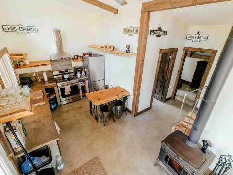 High-angle view of the fully equipped kitchen and dining area in Le Martin pêcheur cabin.