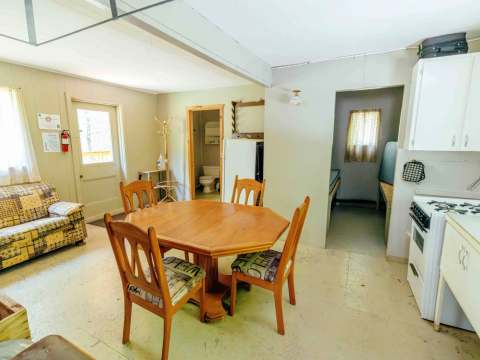 The open area includes a dining room, a functional kitchen, and a comfortable living room.