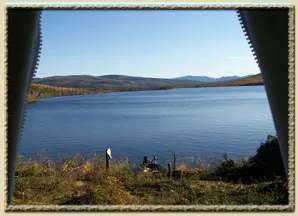 View of the lake and mountains from the opening of your canvas camp.