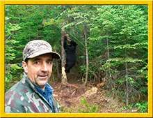 Guide and black bear on the territory at Grand Chelem Aventure, Abitibi-Témiscamingue, Quebec