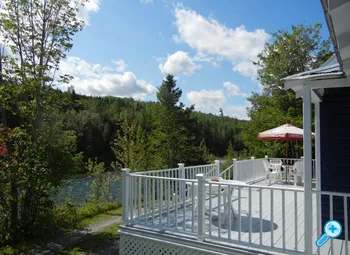 The Lodge terrace offers a direct view of the river and the surrounding forest.
