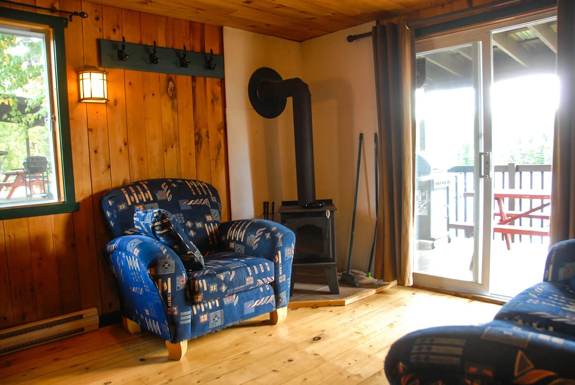 The Avalanche-Nordique cabin living room features a wood stove and comfortable furniture.