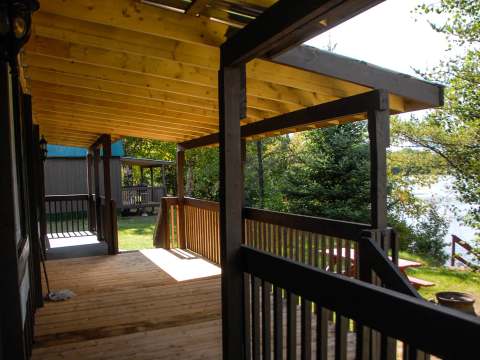 The cottage's covered porch provides an outdoor living space overlooking the nature.
