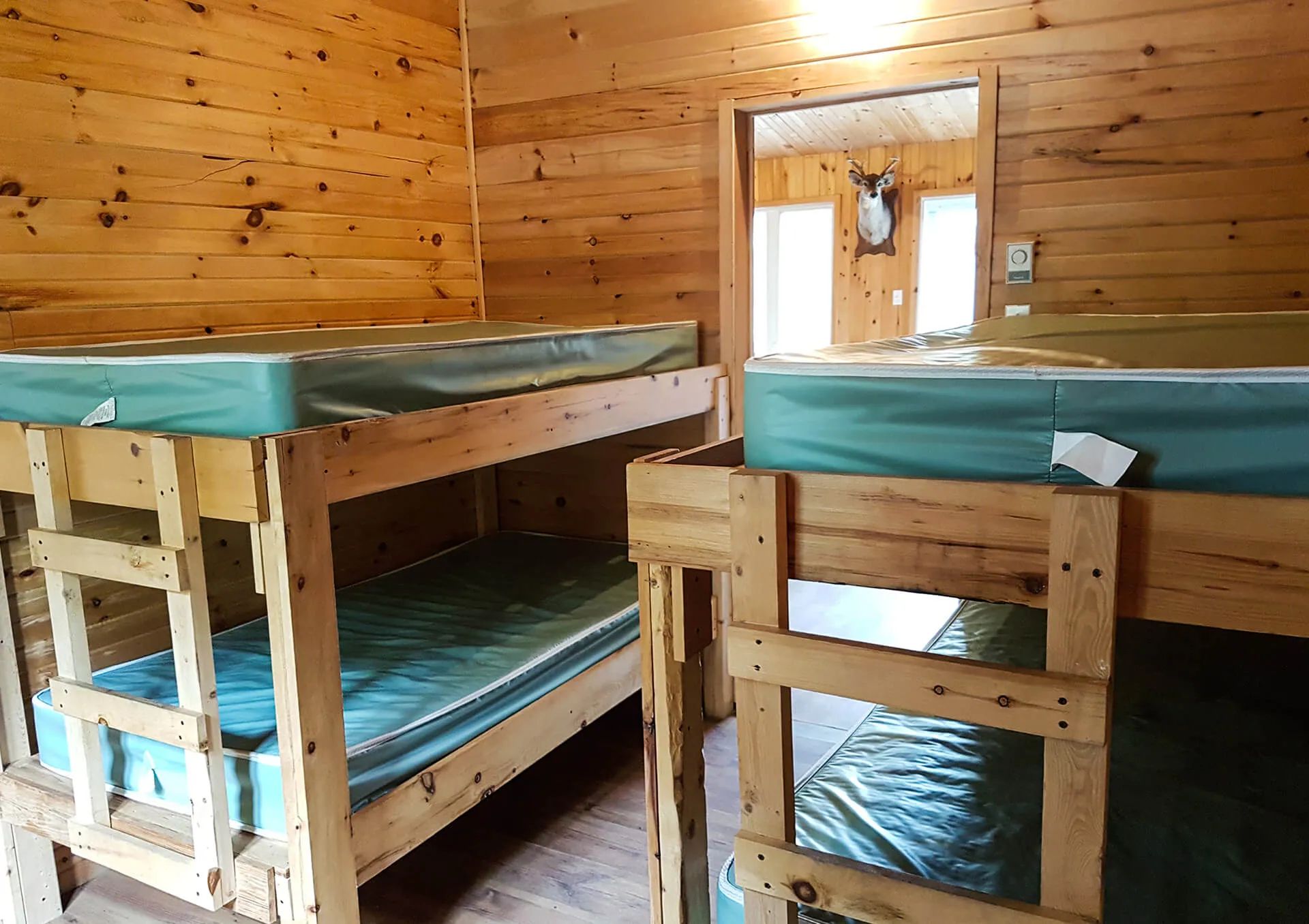 This rustic bedroom is equipped with two wooden bunk beds.