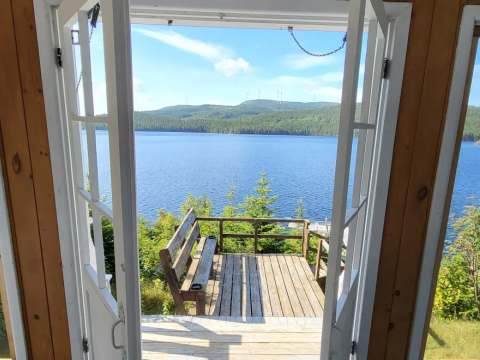 View of the lake from the Manoir patio door overlooking the wooden deck.
