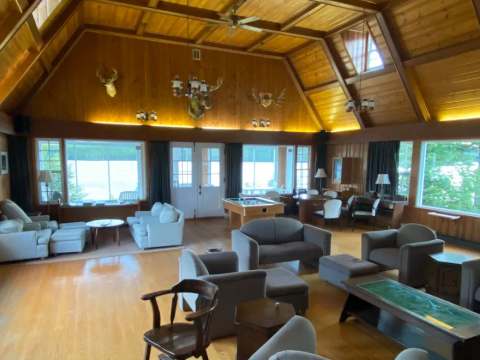 The spacious living room at the Manoir offers a comfortable relaxing area with panoramic lake views.