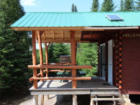 A covered deck with a picnic table and barbecue is provided with the Bellevue cottage.