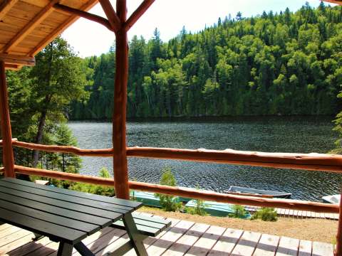 View from the cottage's covered deck overlooking the lake and boats.