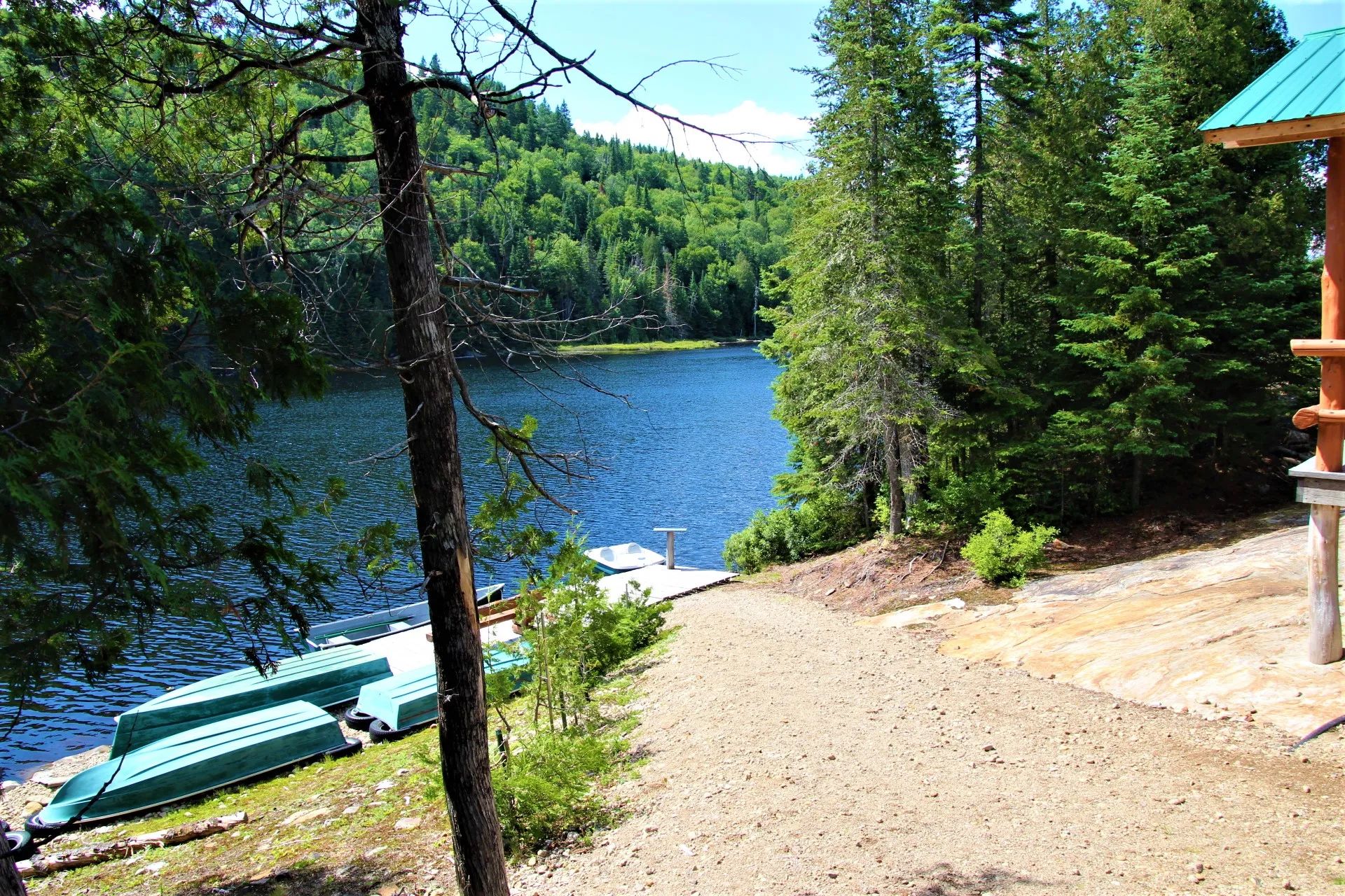 View of the dock and boats from the cabin's porch.