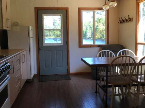 The kitchen and dining area offer a view of the lake.