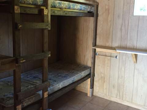 This bedroom at the Benson cabin is equipped with wooden bunk beds.