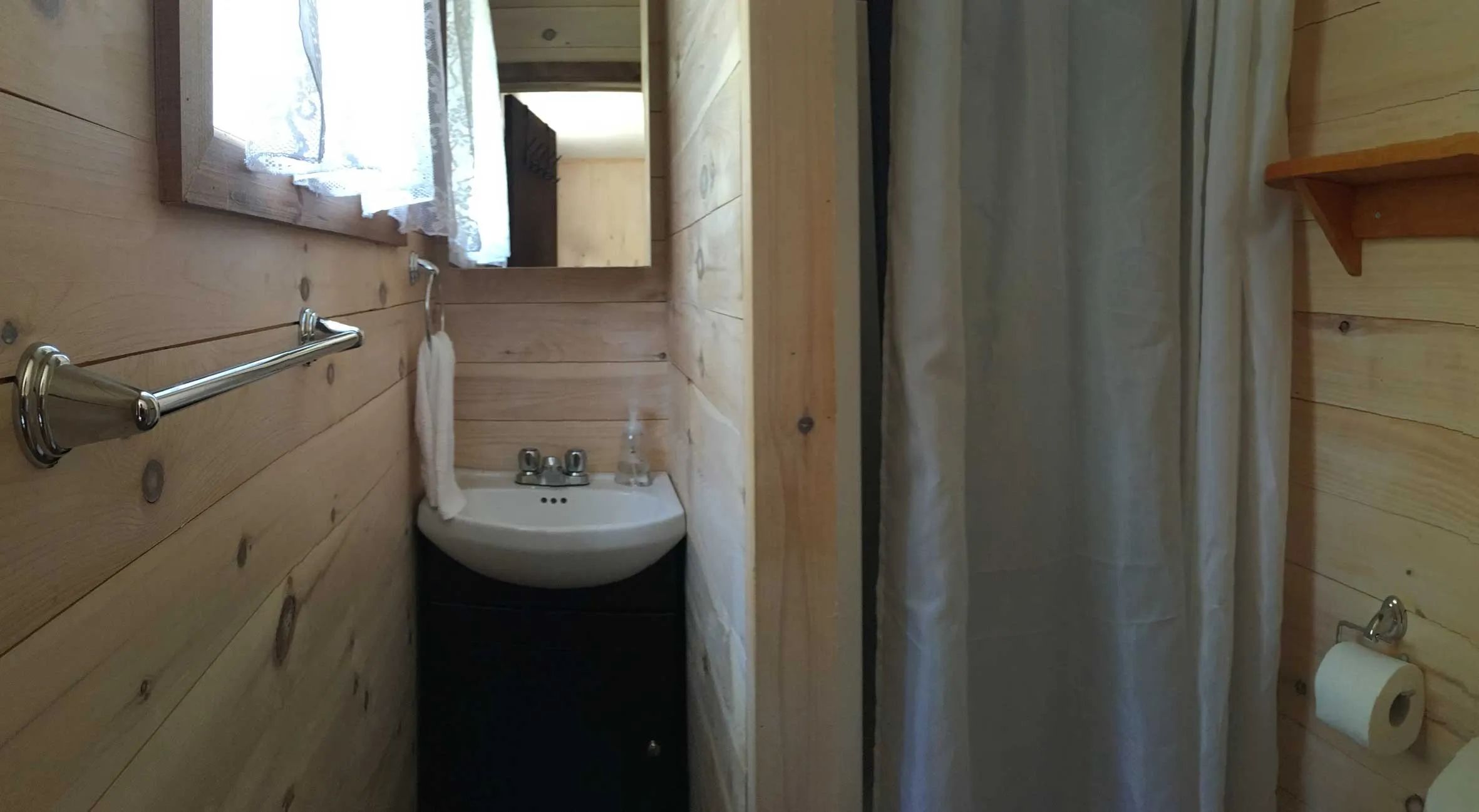 This functional bathroom with shower is located inside the cabin.