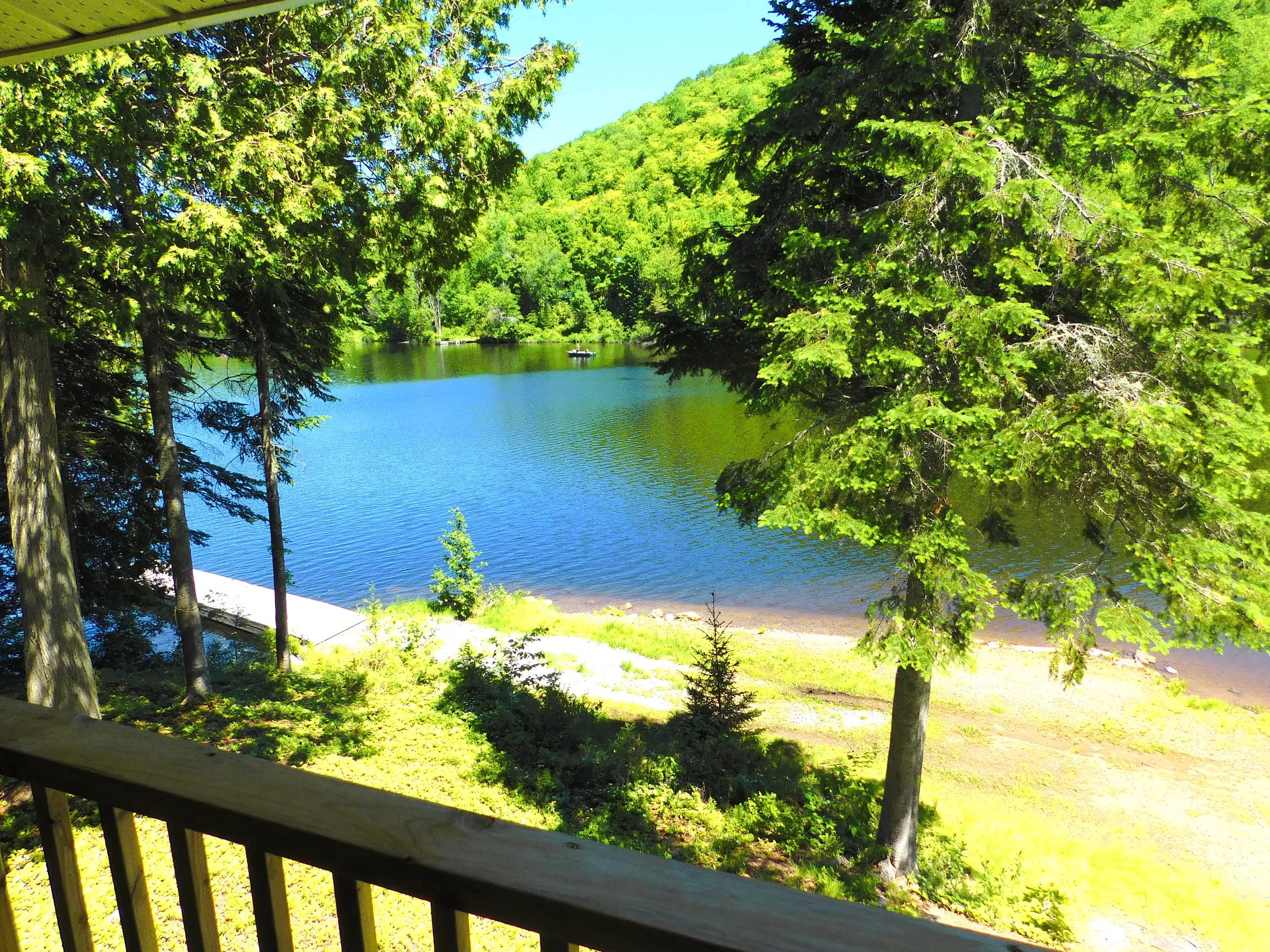 View of the lake and dock from the cabin porch.