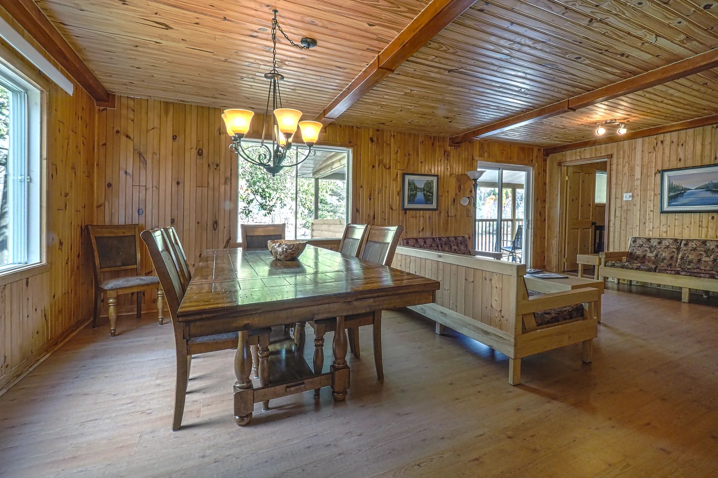 This open area features a wooden dining room and a comfortable living room.