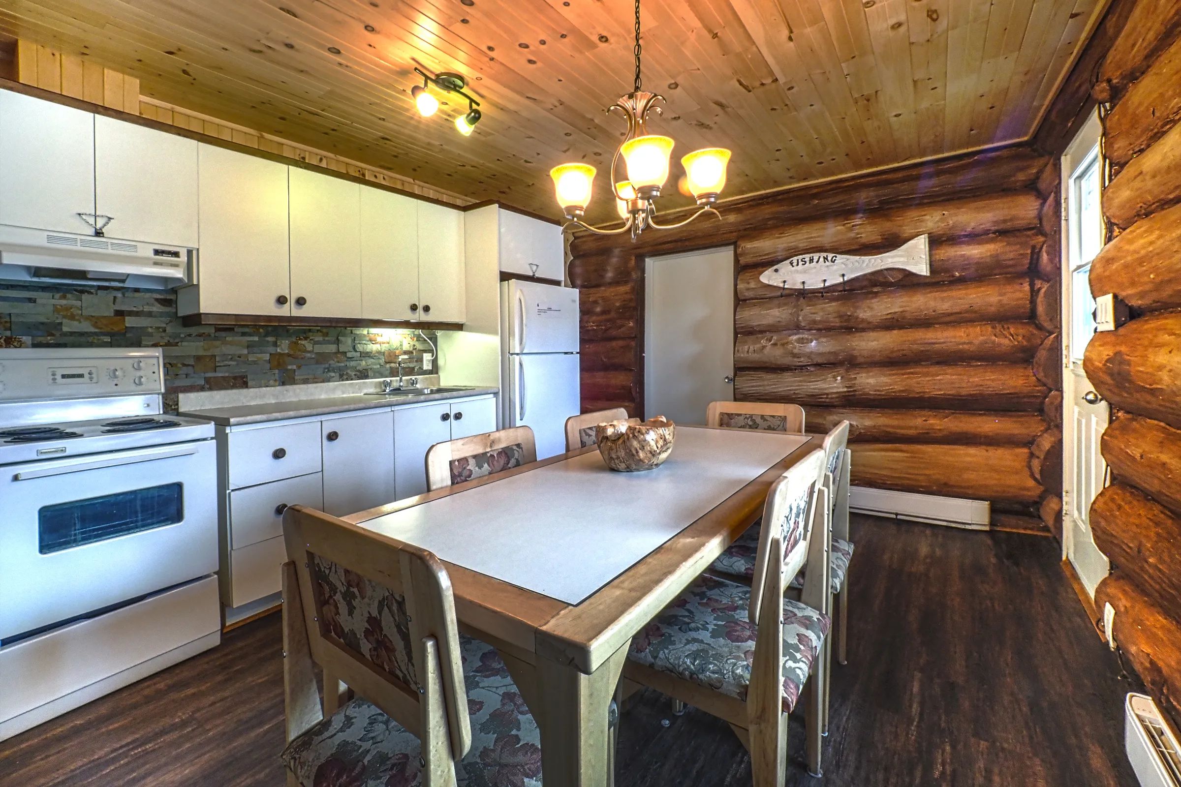 The cottage's functional kitchen and dining area provide a welcoming space for meals.