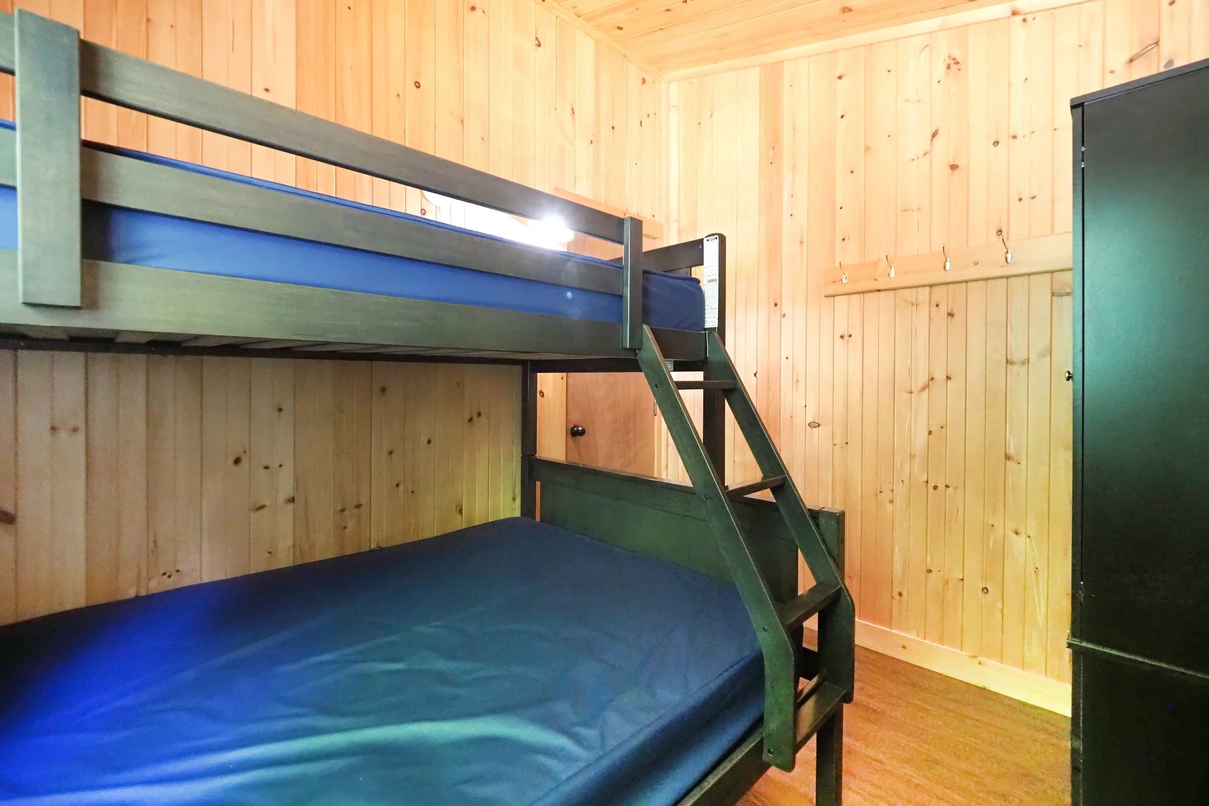 A bedroom with a wooden bunk bed in the cottage.