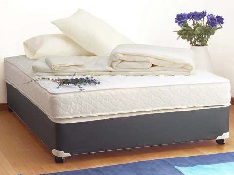 A single bed with white bedding is set up in the room.