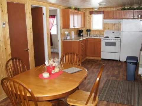 This open-concept kitchen includes a dining table and basic appliances for preparing your meals.