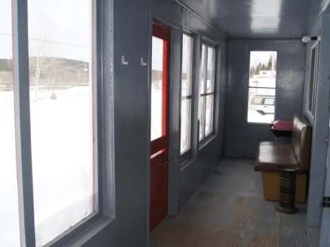 View of the bright, enclosed chalet porch with exterior access.