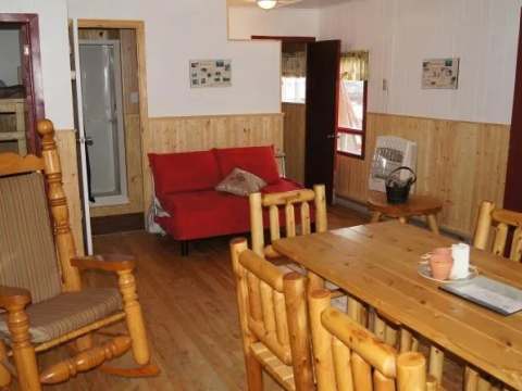 The dining area and living space of the cottage offer a cozy relaxing area.